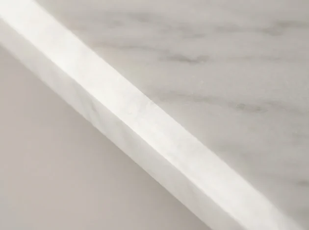 Close-up of the polished bevelled edge of a Bianco Dolomiti Marble threshold