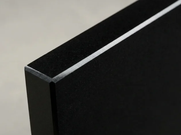 Close-up of the polished bevelled edge of a Black Absolute Granite threshold