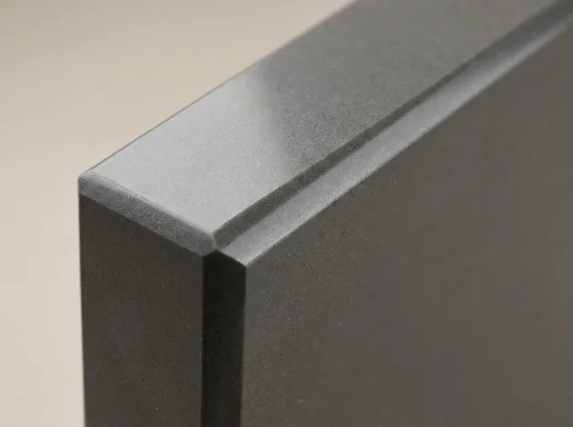 Close-up of the polished bevelled edge of a Grey Caesarstone threshold