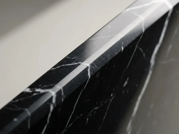 Close-up of the polished bevelled edge of a Nero Marquina Marble threshold