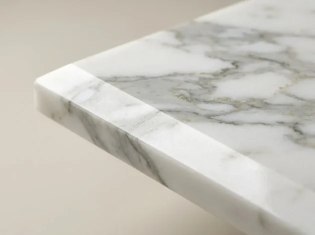 Close-up of the polished bevelled edge of a Statuario Marble threshold
